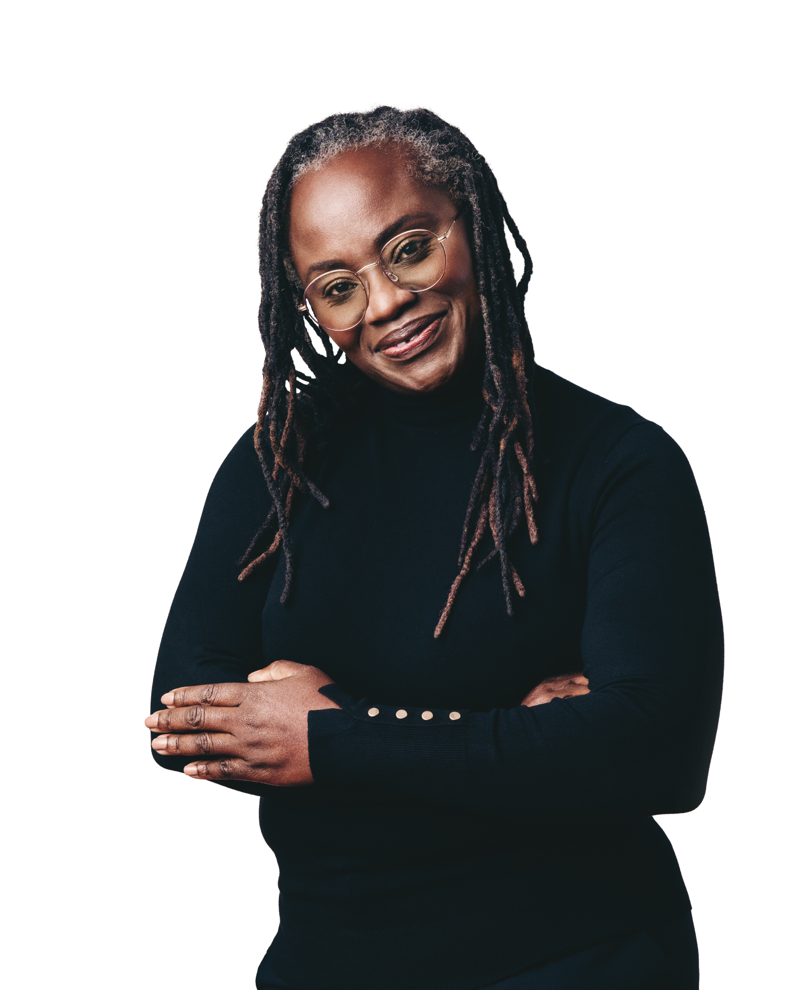 woman in black sweater and long brown braids smiling at the camera with her arms crossed over her chest.