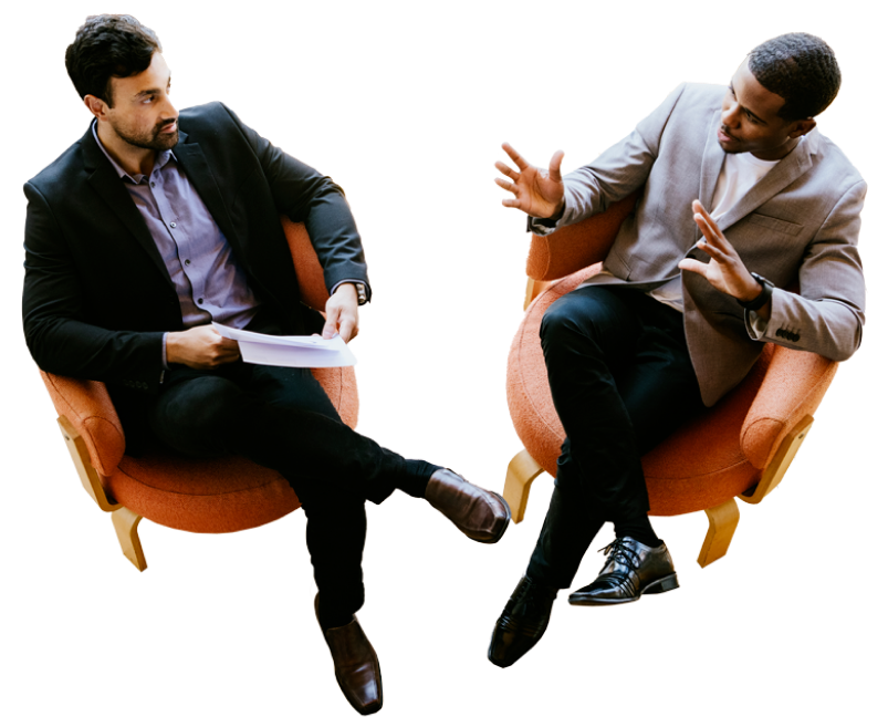 two men talking to each other sitting down